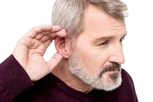 Man with hand behind ear — Stock Photo, Image