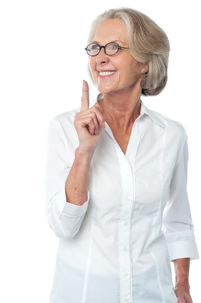 Woman pointing her finger upwards — Stock Photo, Image