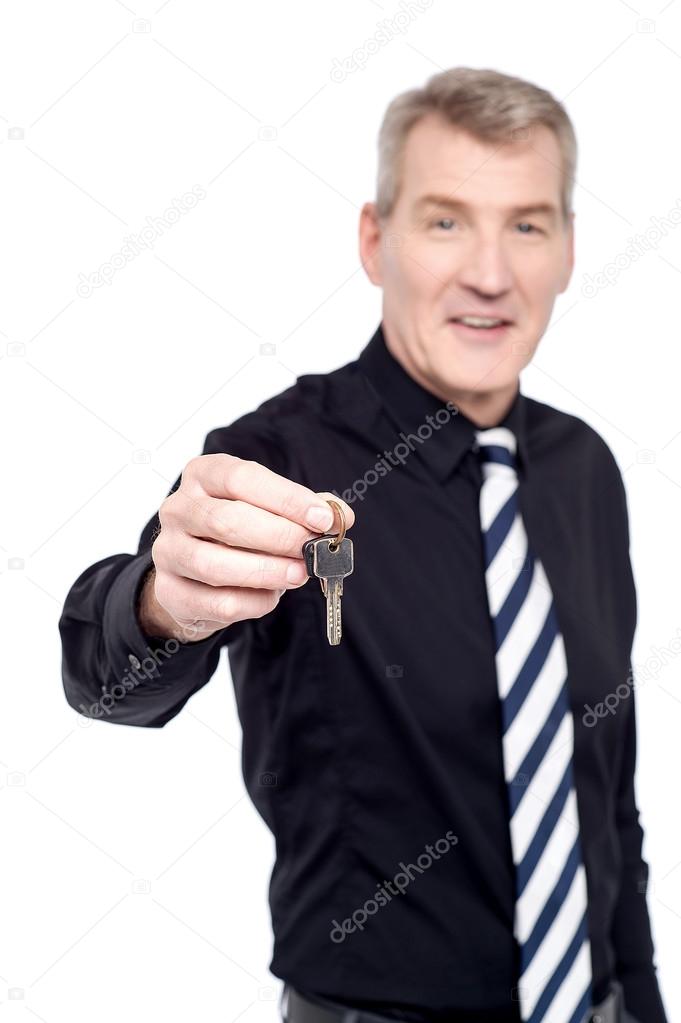 Real estate agent showing keys