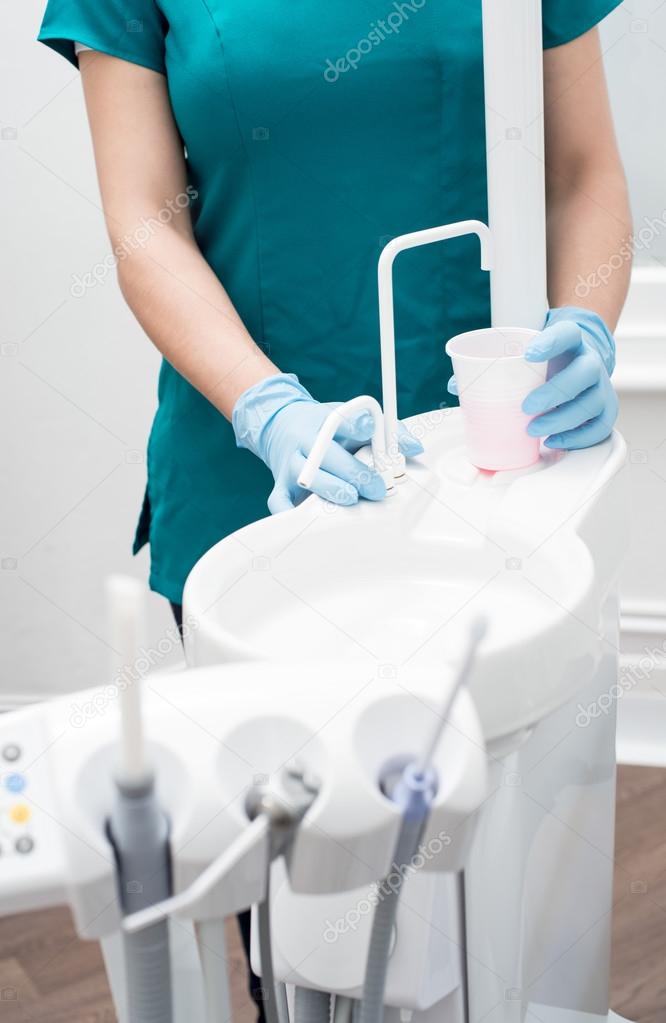 Dental assistant in modern clinic