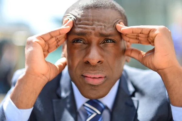 Businessman with hands on his forehead — Stock Photo, Image