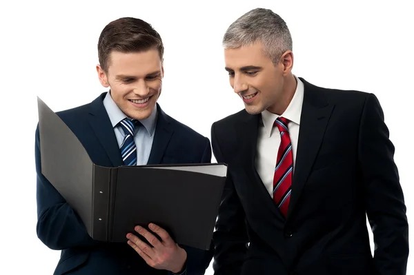 Business partners looking a file folder — Stock Photo, Image