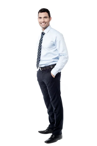 Male executive with hands in pockets — Stock Photo, Image