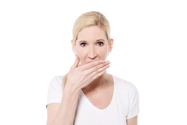 Woman with hand over mouth — Stok fotoğraf