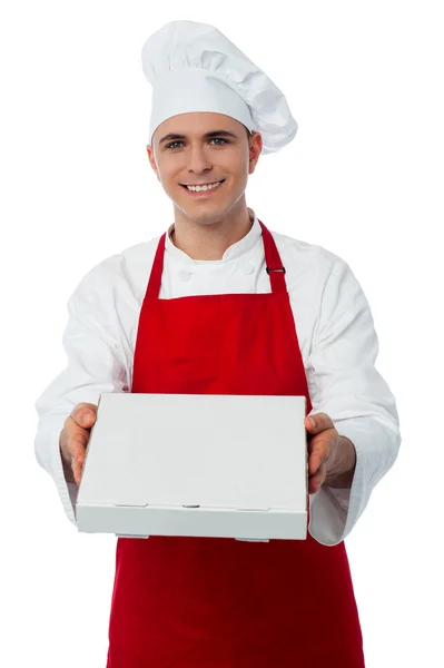 Chef offering you a pizza box — Stock Photo, Image