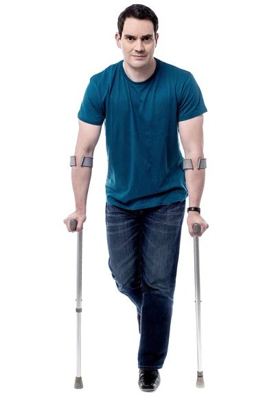Man walking with crutches — Stock Photo, Image