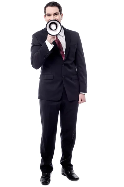 Businessman making announcement with loudhailer — Stock Photo, Image