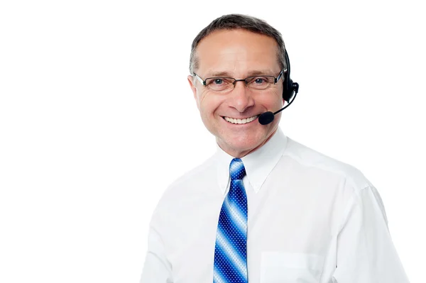 Senior call center executive with headset — Stockfoto