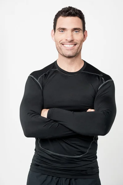 Male athlete with folded arms — Stockfoto