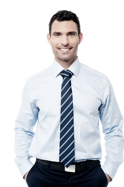 Male executive with hands in pockets — Stock Photo, Image