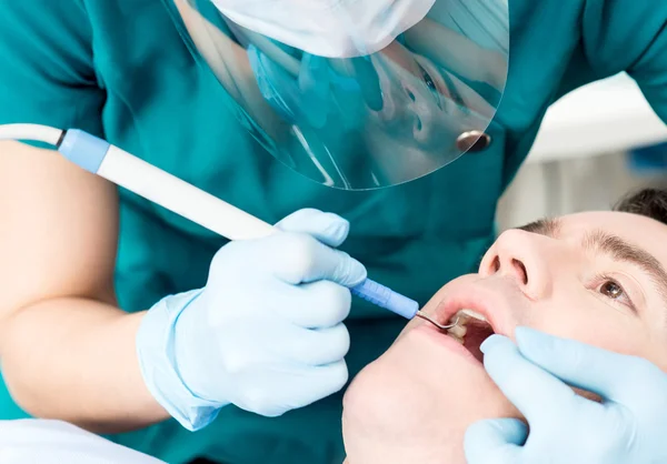 Close up of dentist treat a man teeth — Stock Fotó