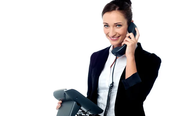 Smiling secretary attending business call — Zdjęcie stockowe