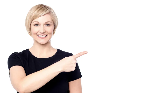 Woman pointing finger to copy space — Stock Photo, Image