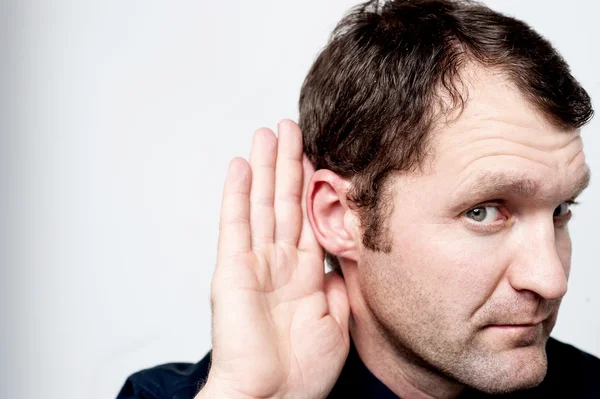 Man secretly listening on conversation — Stock Photo, Image