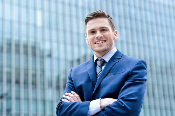 Zakenman poseren met gevouwen wapens — Stockfoto