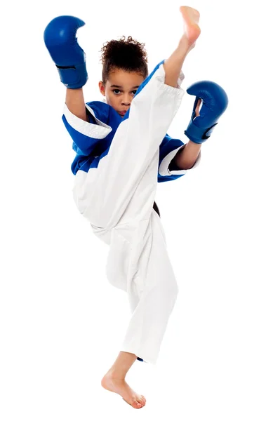 Karate girl kicking by a leg — Stock Photo, Image