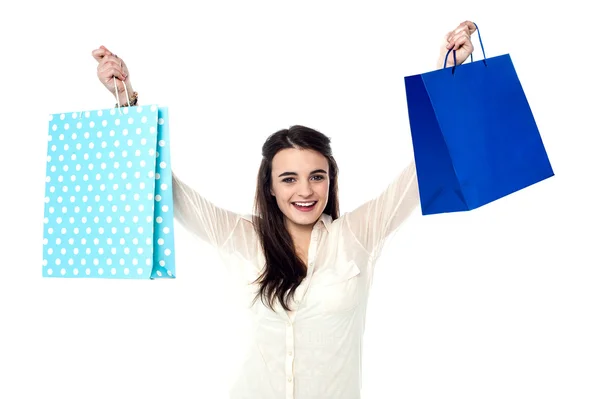 Girl holding up her shopping bags — Stock Photo, Image