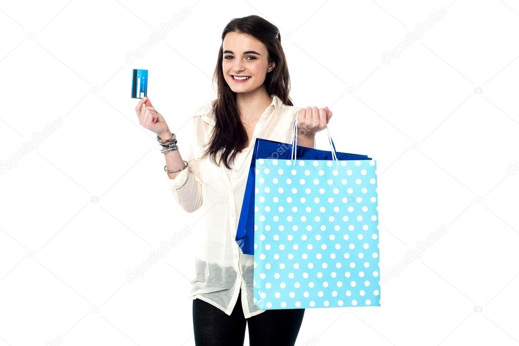 Teen girl showing credit card