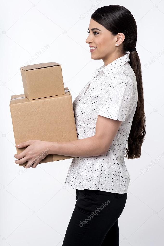 woman carrying stack of boxes