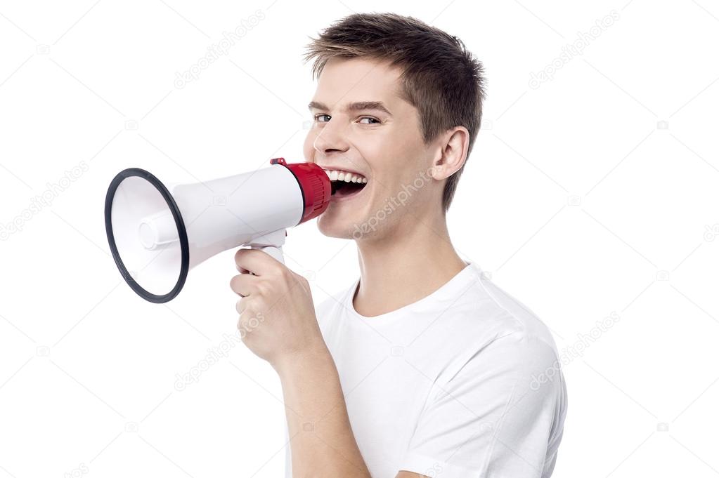 man proclaiming into megaphone