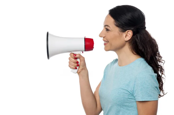 Woman advertising over megaphone — Stock Photo, Image