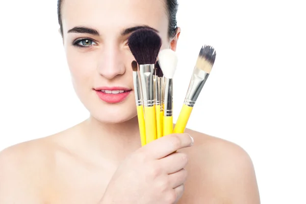 Girl holding makeup brushes — Stock Photo, Image