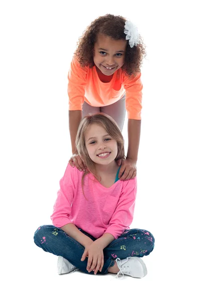 Girl standing behind her friend — Stock Photo, Image