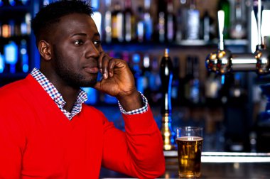 african guy with a glass of beer