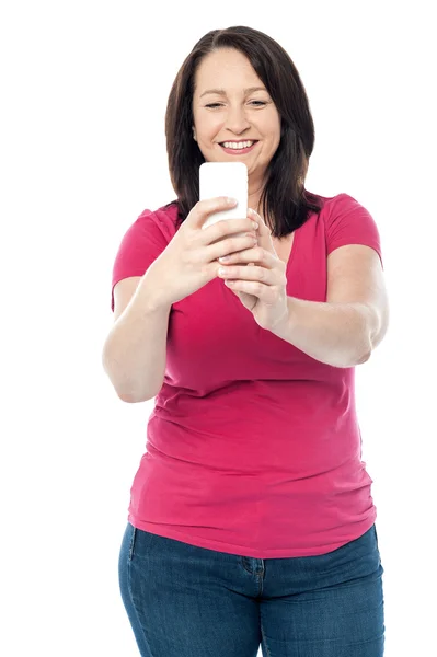 Middle aged woman taking a picture — Stock Photo, Image