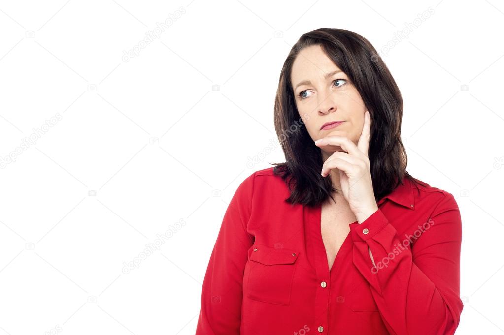 Woman in red thinking deeply