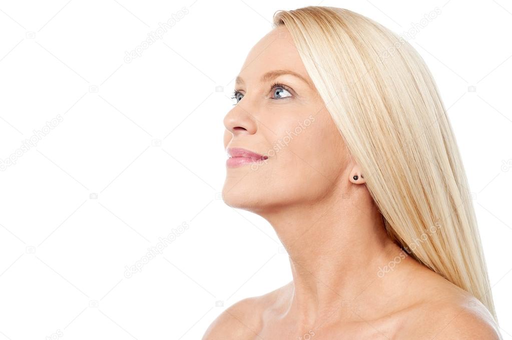 woman with bare shoulders looking upwards