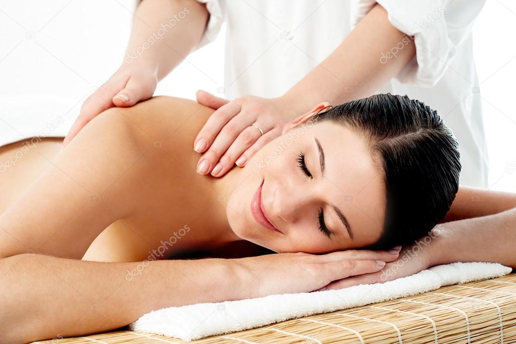 Therapist giving massage to woman