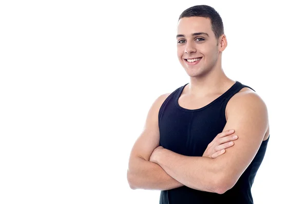 Muscular guy posing with arms crossed — Stock Photo, Image