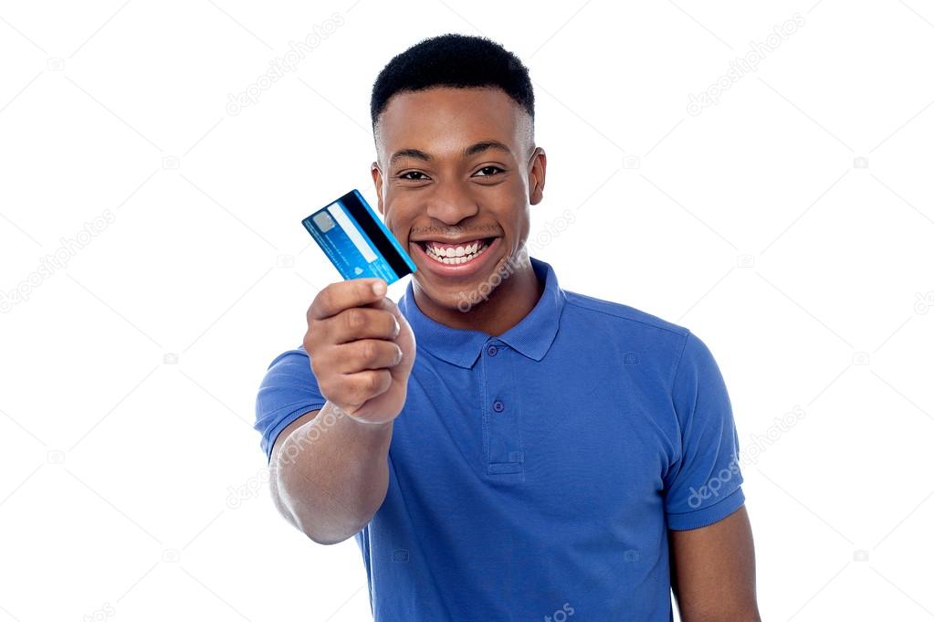 young boy showing credit card