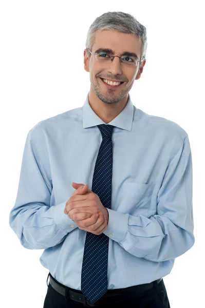 Businessman posing with clasped hands — Stock Photo, Image