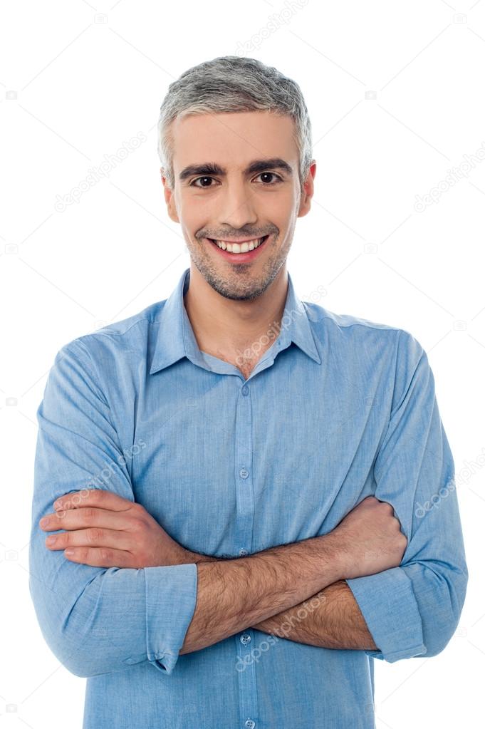 Young smiling guy with arms crossed