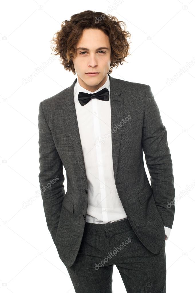 man posing in tuxedo