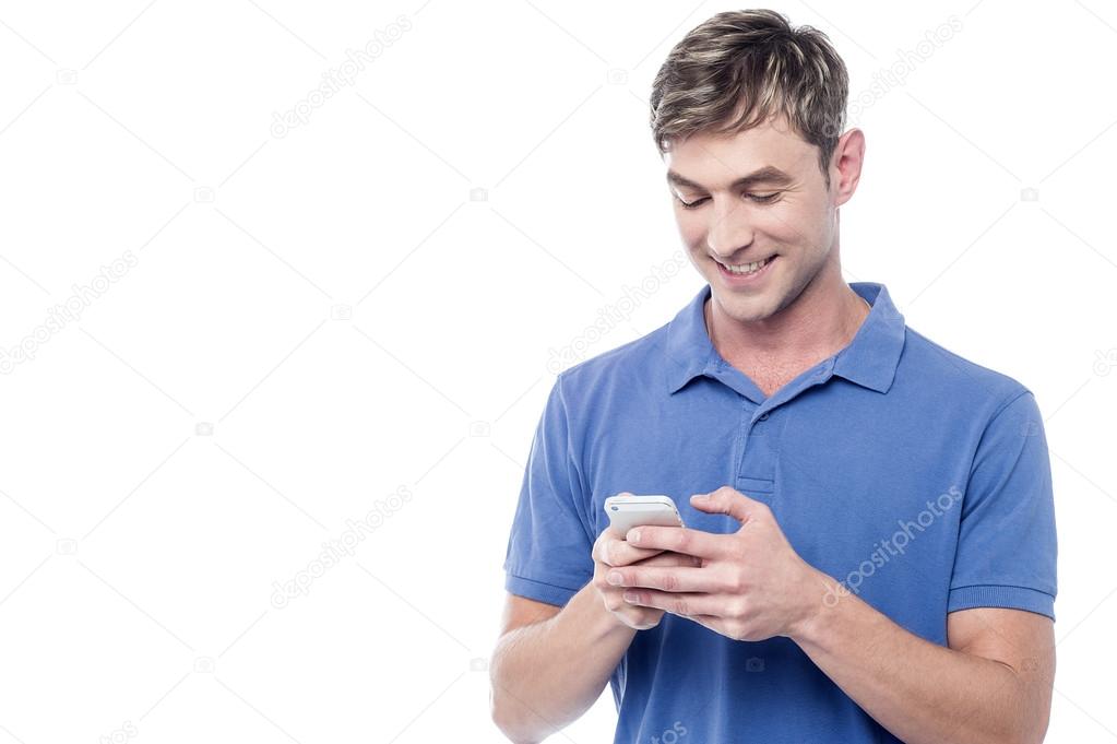 young guy busy on mobile phone