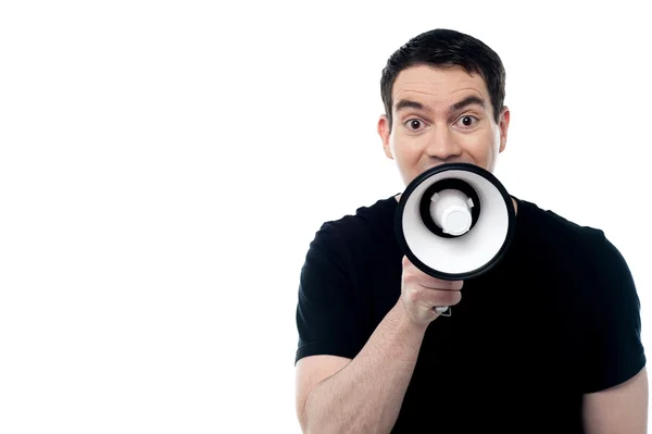 Caucasian man speaking through megaphone — Stock Photo, Image