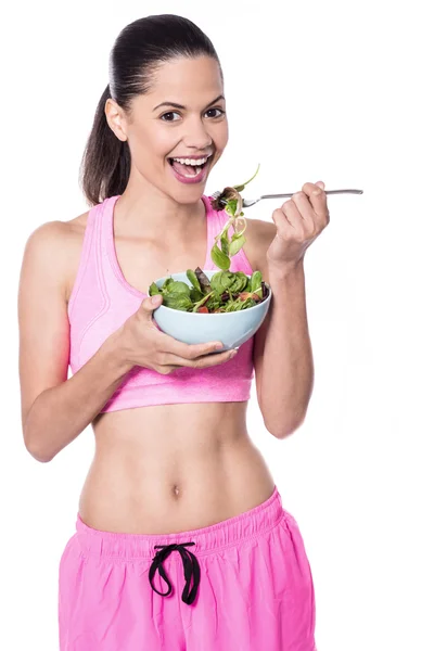 Vältränad kvinna äta grönsakssallad Stockfoto