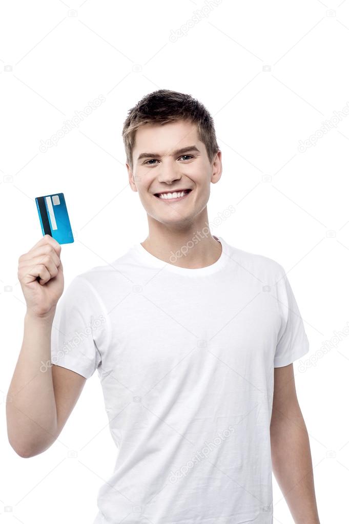 young man showing credit card