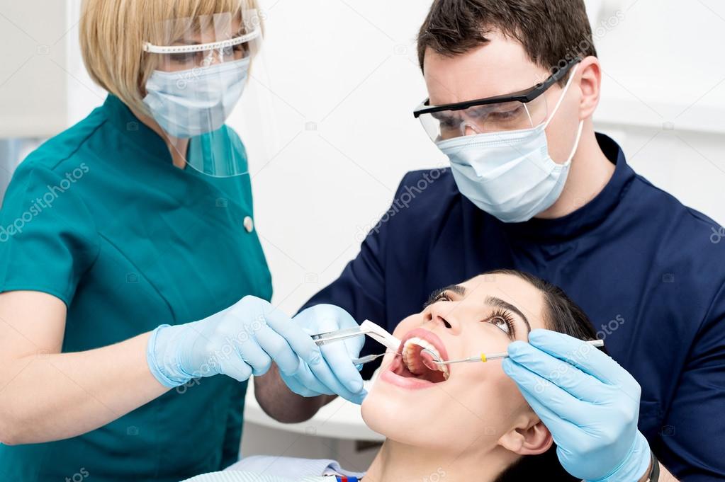 Dentist examining gums of patient