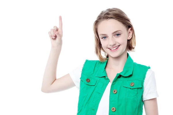 Pretty girl pointing upwards — Stock Photo, Image