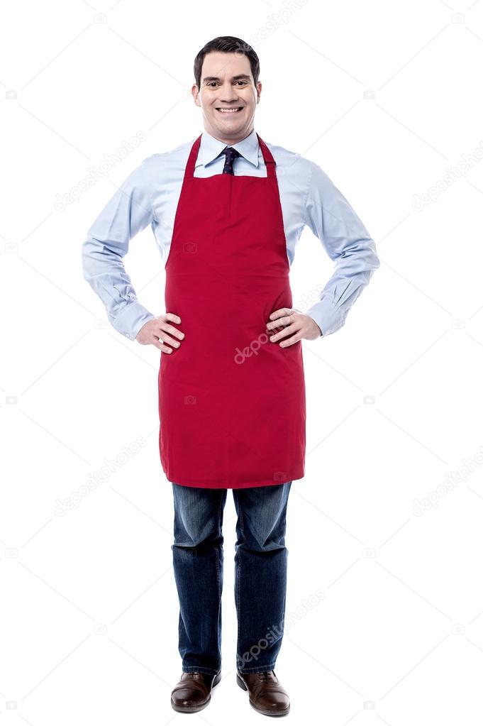 Male executive wearing apron