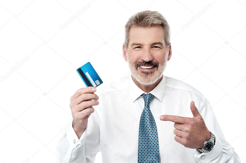 Senior businessman showing debit card