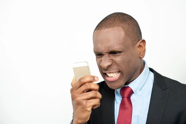 Angry businessman yelling through cellphone — Stock Photo, Image