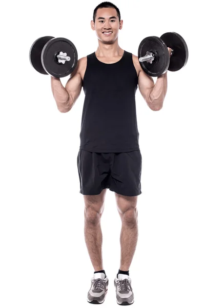 Young man lifting dumbbells — Stock Photo, Image
