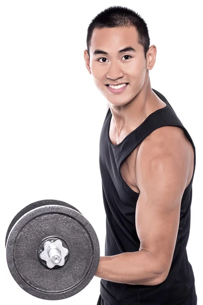 Young man lifting a dumbbell — Stock Photo, Image