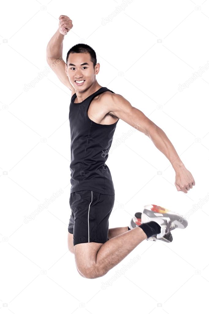 Young sports man jumping in the air