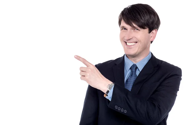 Executive pointing finger at something — Stock Photo, Image